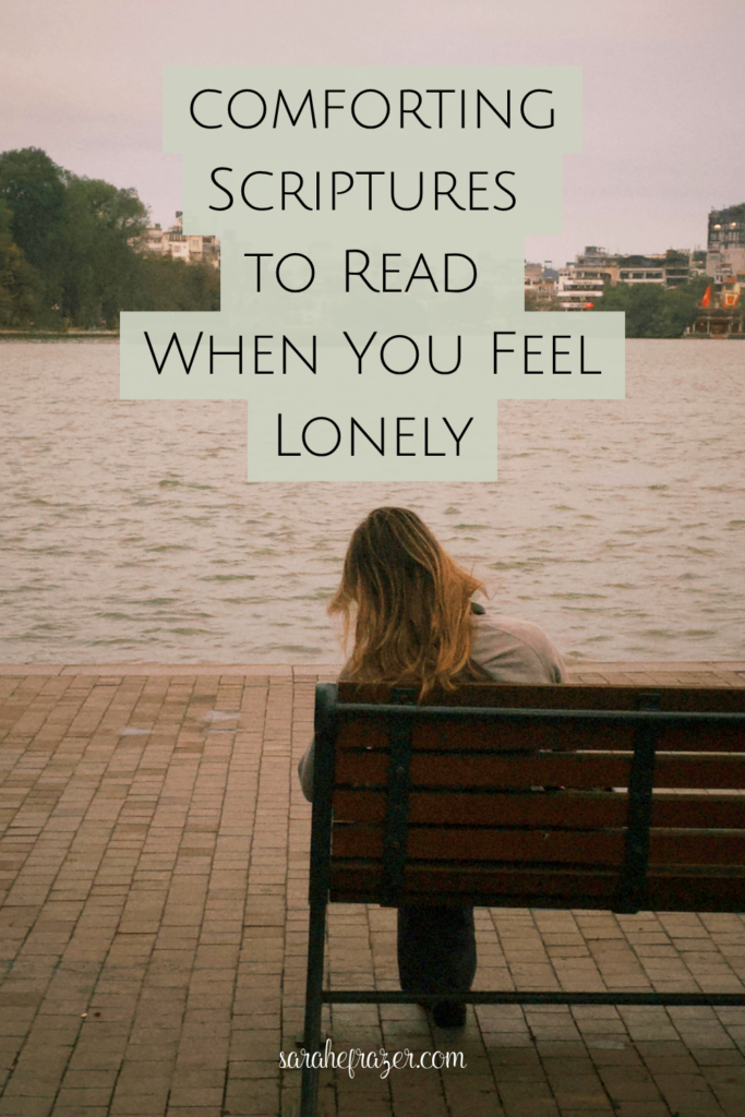 Woman sits on bench overlooking water. Text overlay reads: scripture to read when you feel lonely