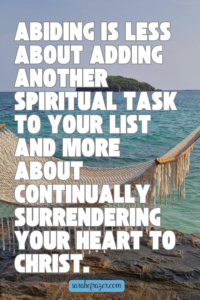 abiding quote on background of a white hammock overlooking the ocean
