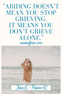 A Christian Quote for Grief and Depression with a womn walking on the beach in the background. She's wearing a tan sweater and touching her hair.