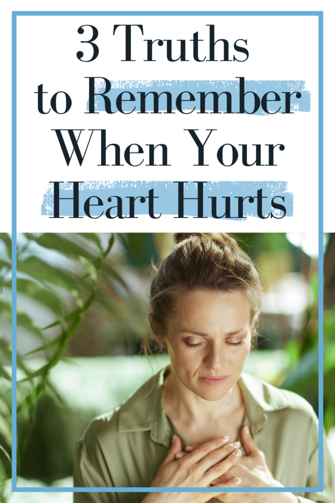 Women praying with hand over her heart with plants nearby. Text reads: 3 truths to remember when your heart hurts