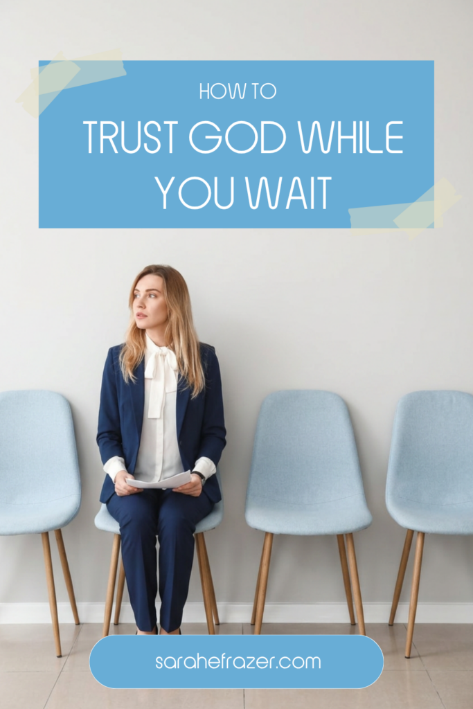 Text overlay reads: how to trust god while you wait. A woman in a navy suit sits waiting on an office chair