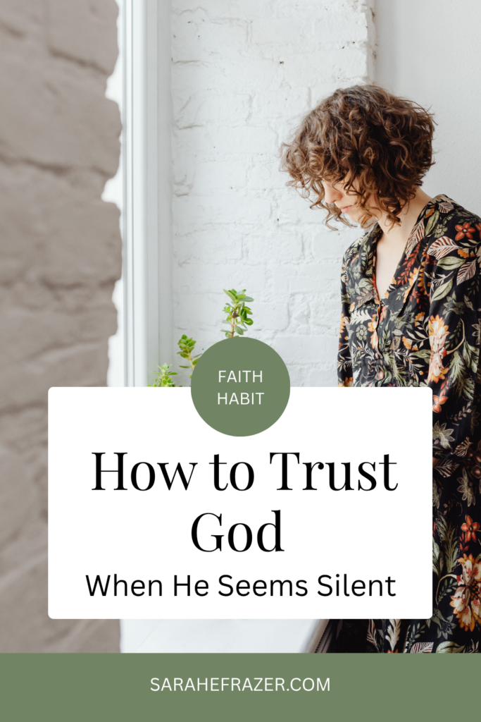 women bends over near a window with a small plant beside her. Text reads: how to trust God when he seems silent